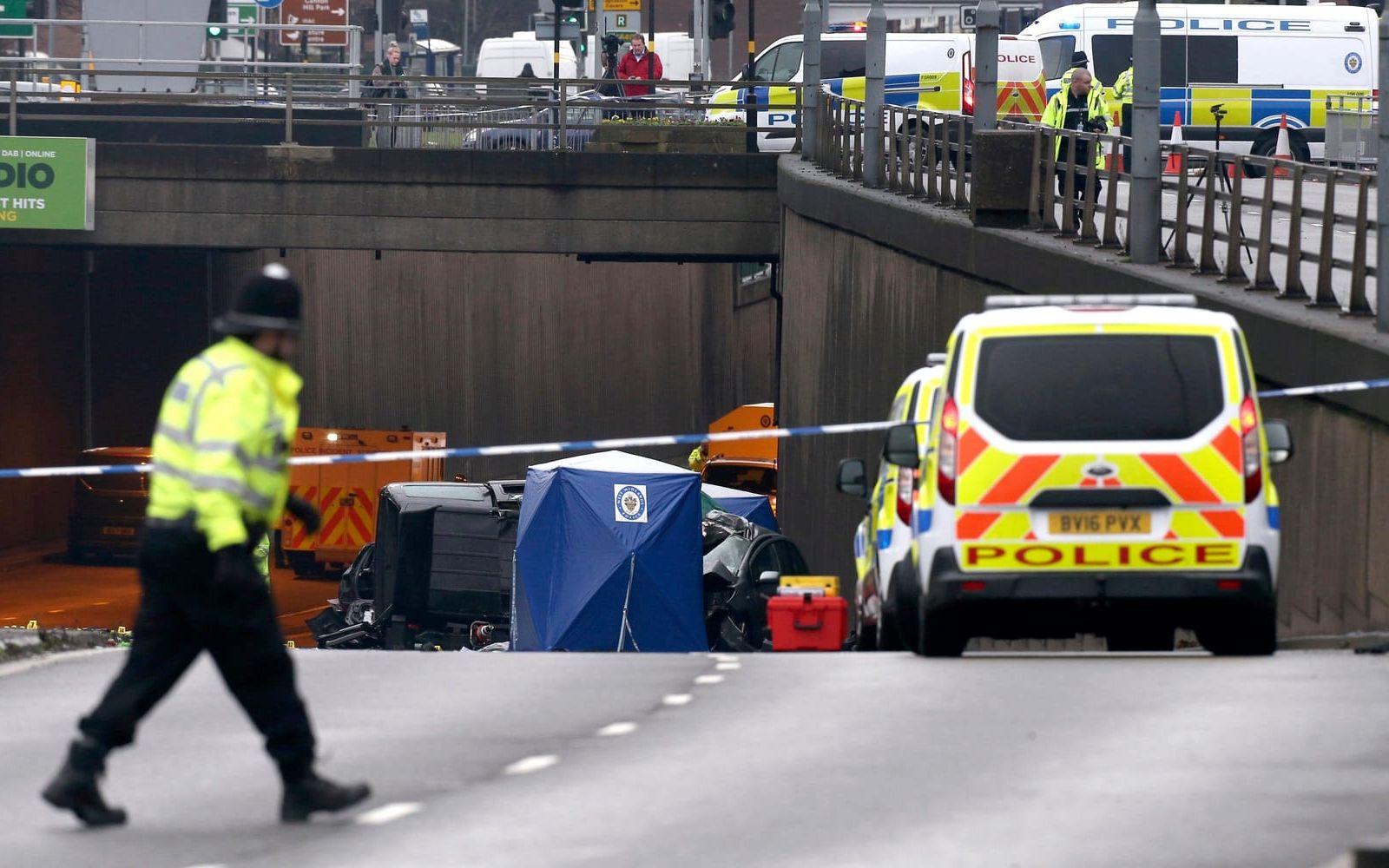 Emergency vehicles attend the scene of a multi vehicle crash at the entrance of an underpass near Edgbaston, in Birmingham, England, Sunday Dec. 17, 2017, which left six people dead and a seventh critically injured. (Aaron Chown/PA via AP)