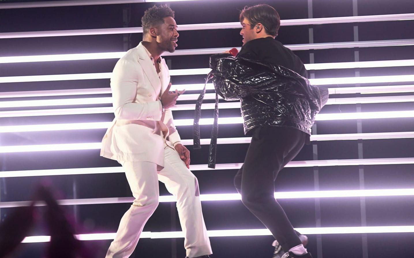 John Lundvik går upp på scen och dansar med Benjamin Ingrosso som sjunger sitt bidrag för andra gången under lördagens första deltävling i Melodifestivalen 2018 i Löfbergs Arena.


