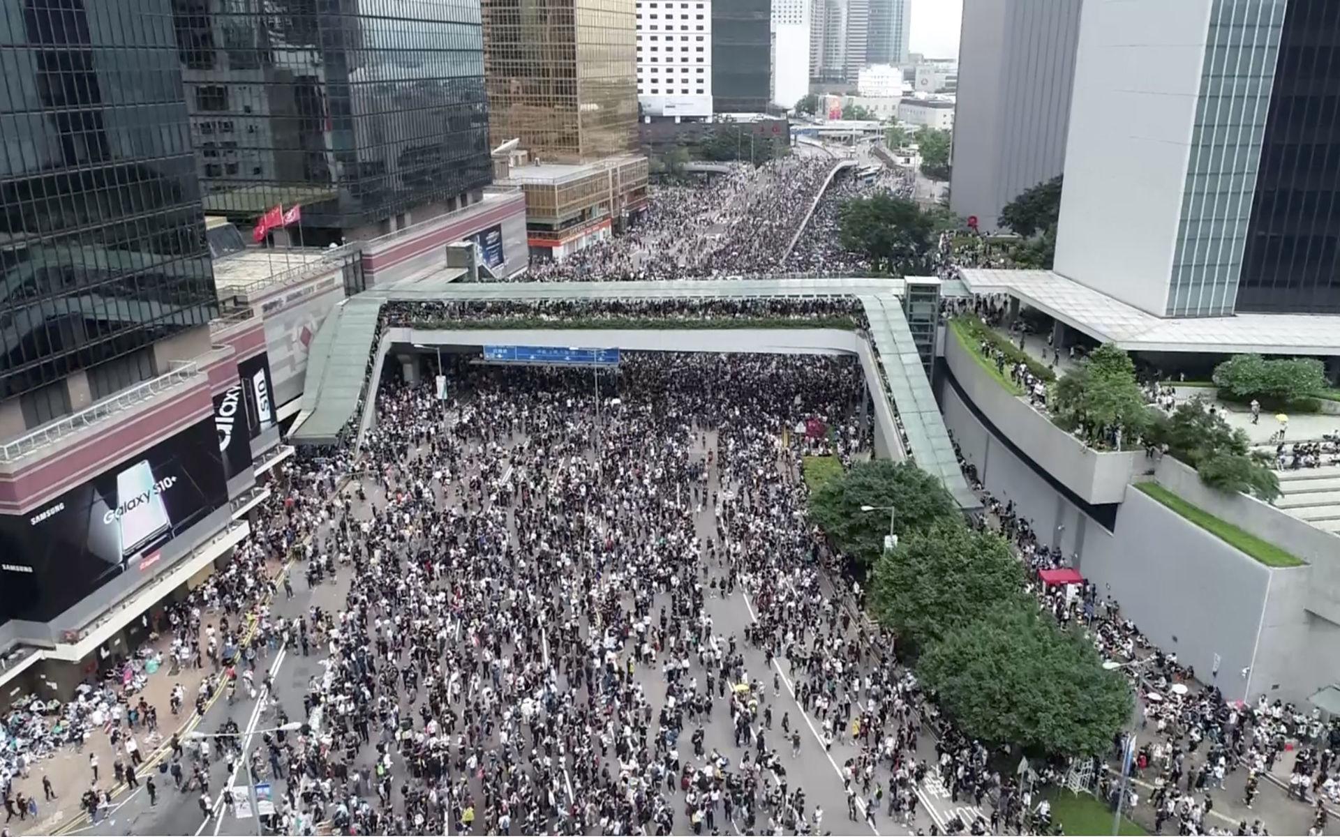 In this image made from aerial video, protesters gather in the streets outside the Legislative Council in Hong Kong, Wednesday, June 12, 2019. Thousands of protesters have blocked access to Hong Kong&apos;s legislature and government headquarters in a bid to block debate on a highly controversial extradition bill that would allow accused people to be sent to China for trial. (Apple Daily via AP)