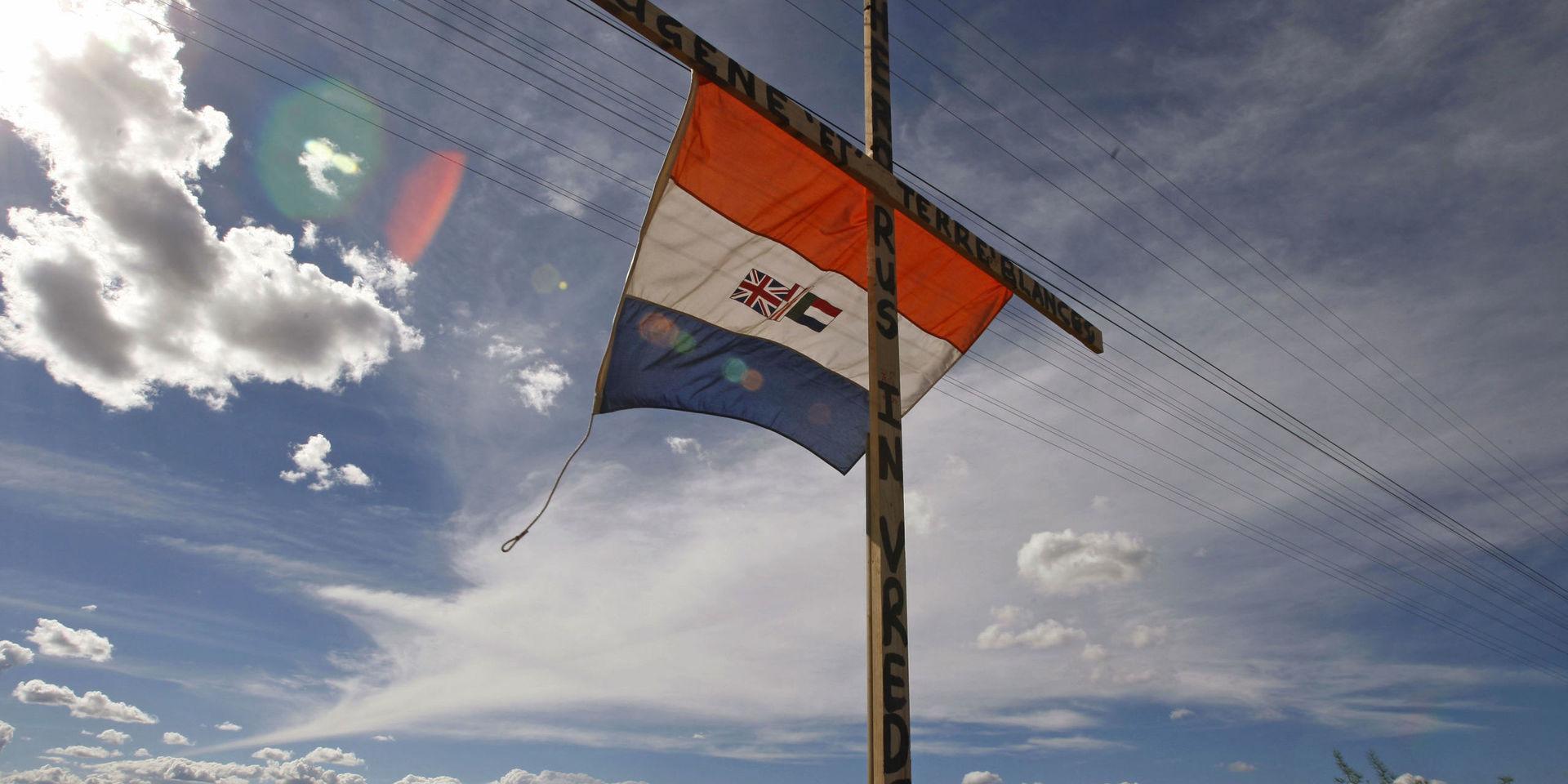 Den tidigare sydafrikanska flaggan på ett kors med en hyllning till den högerextreme politikern Eugene Terreblanche. Arkivbild.