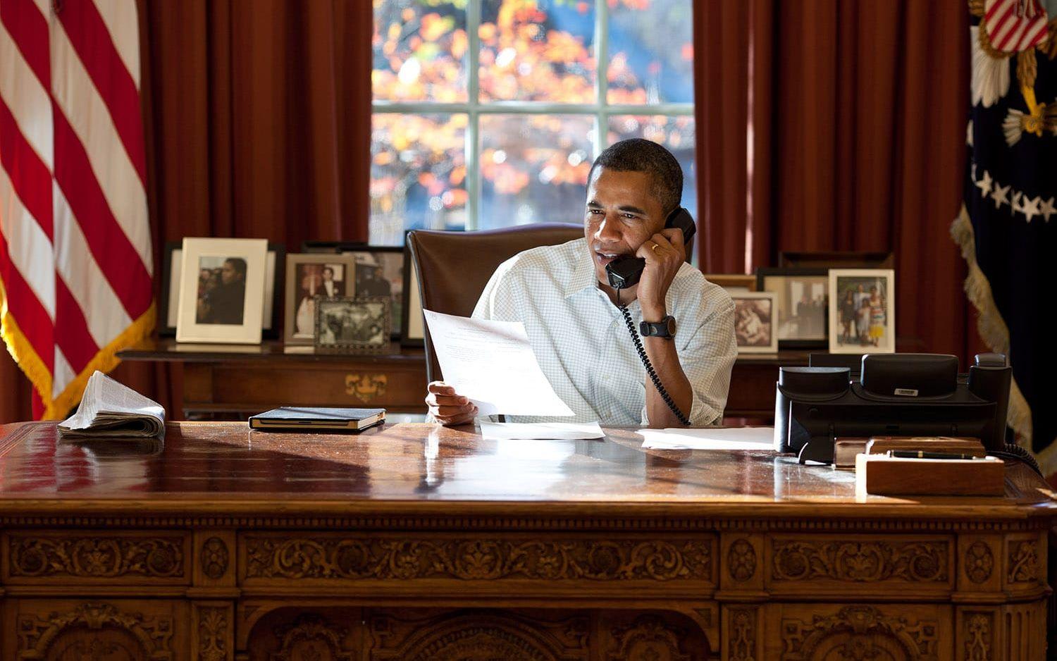 24 november, 2011: Fotografen Pete Souza noterar att han har mängder av bilder där presidenten talar i telefon. Här, i ett samtal där presidenten ringer runt till soldater på Thanksgiving, reflekterades ljus från papperet på ett sällsynt stämningsfullt sätt.  Foto: Pete Souza / Vita Huset