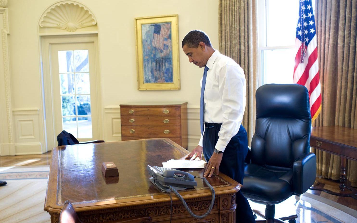21 januari, 2009: Barack Obamas första dag på kontoret. Han passar på att ögna igenom några papper innan ett möte. Foto: Pete Souza / Vita Huset
