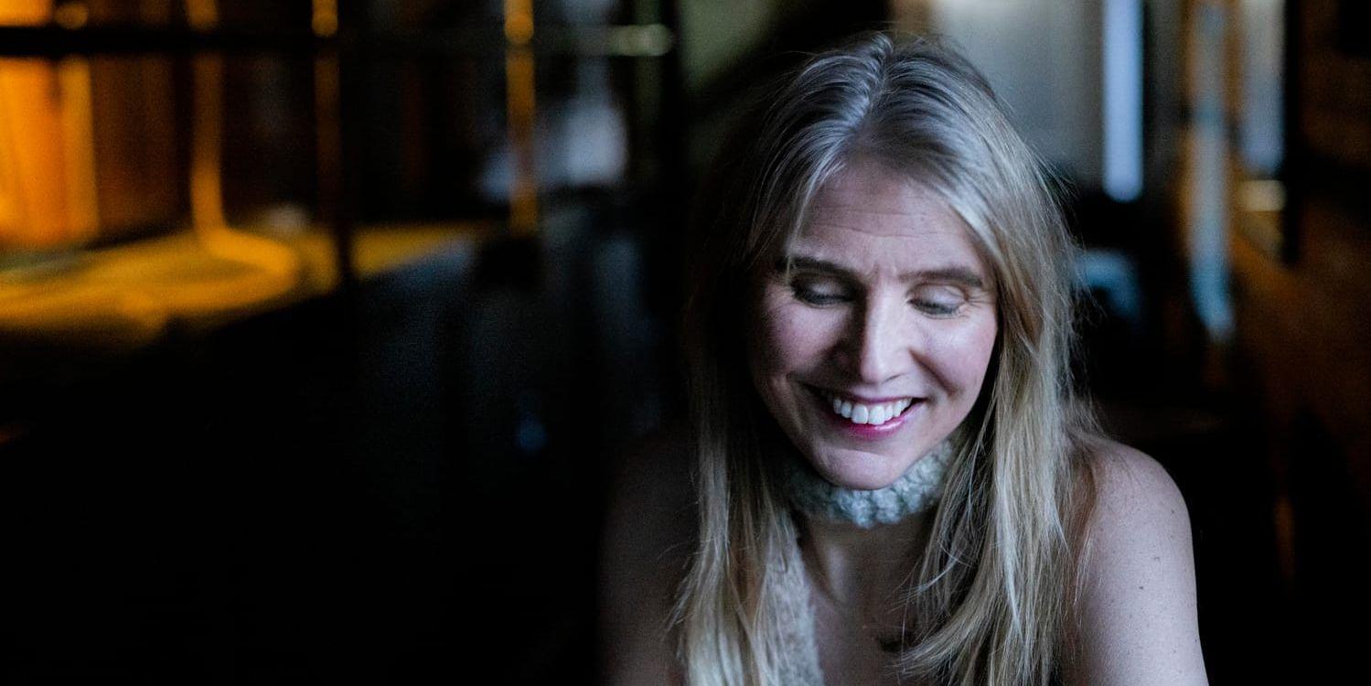 Författaren Amanda Romare skrattar på en bar i Malmö. 