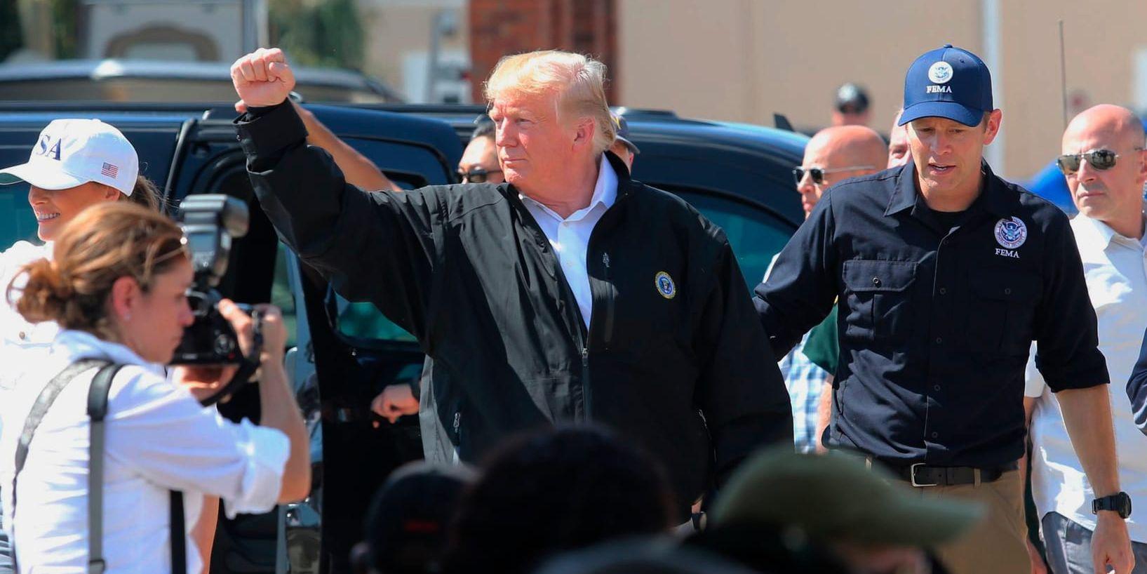 President Donald Trump lyfter näven vid ett besök i Lynn Haven, Florida, efter orkanens framfart.