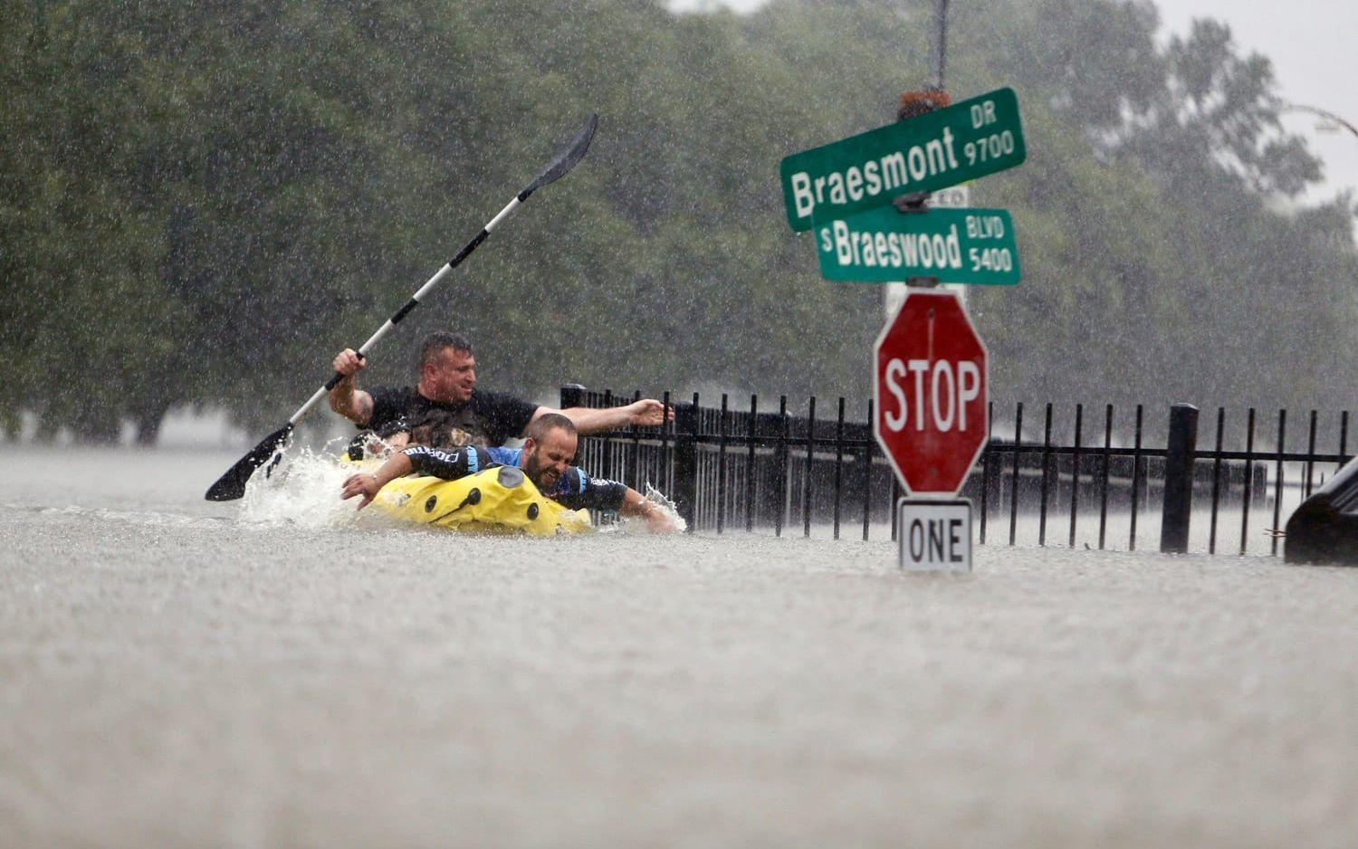 Två kajakpaddlare försöker kämpa mot vattnets kraft i Houston. Bild: Mark Mulligan/TT