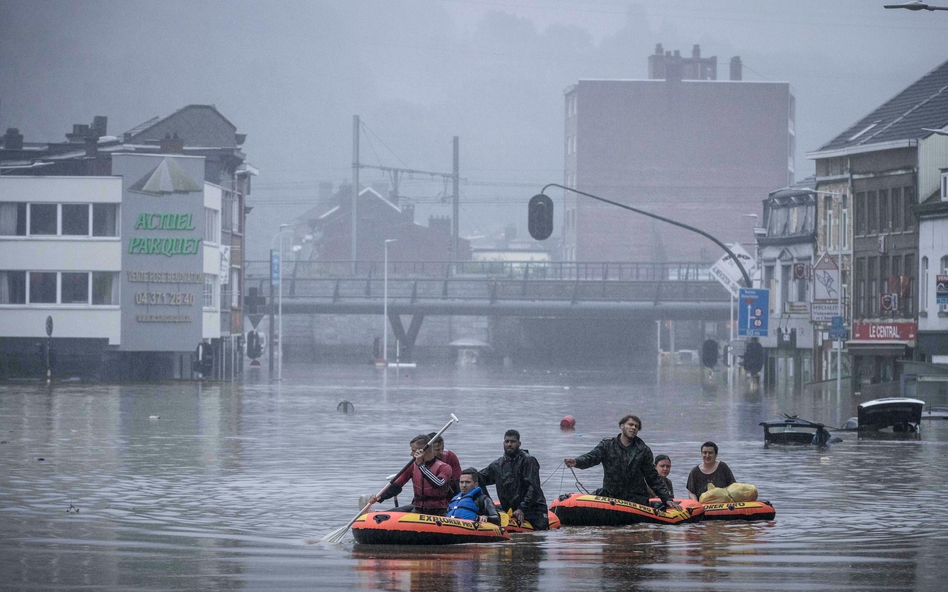 People use rubber rafts in floodwaters after the Meuse River broke its banks during heavy flooding in Liege, Belgium, Thursday, July 15, 2021. Heavy rainfall is causing flooding in several provinces in Belgium with rain expected to last until Friday. (AP Photo/Valentin Bianchi)  VLM159
