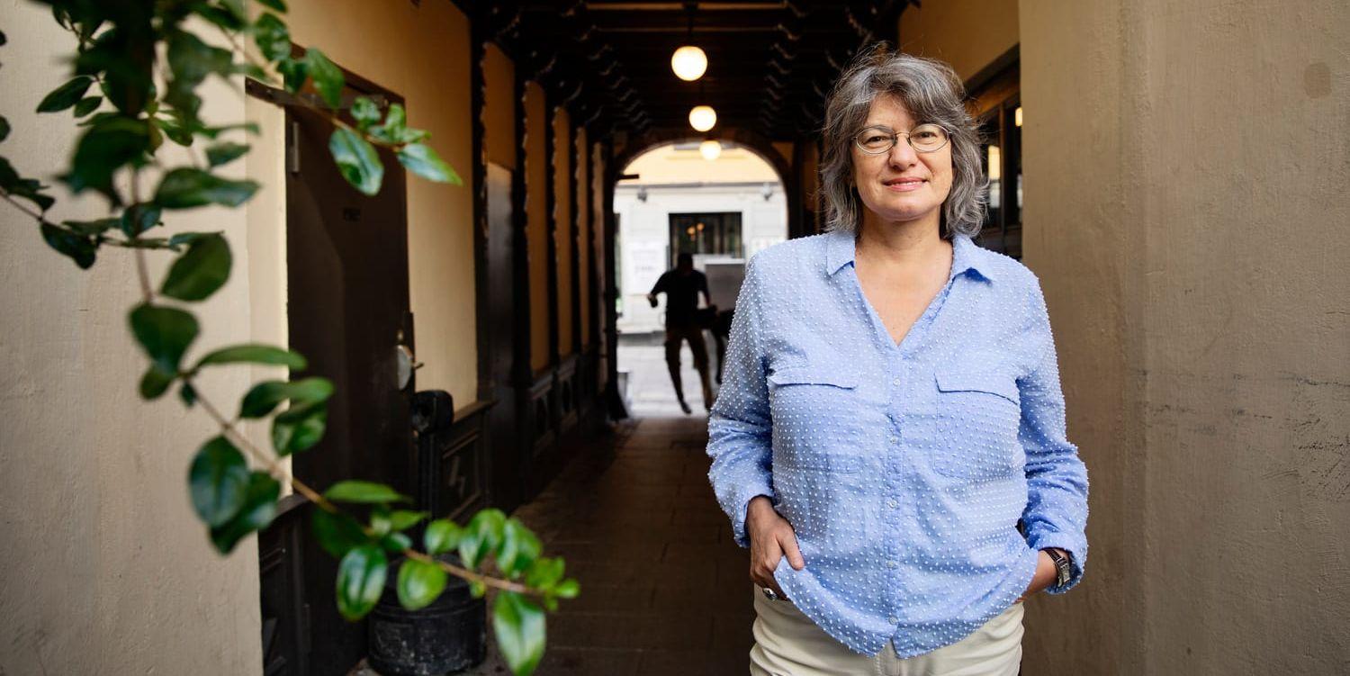 Liria Ortiz i blå blus ståendes på en innergård