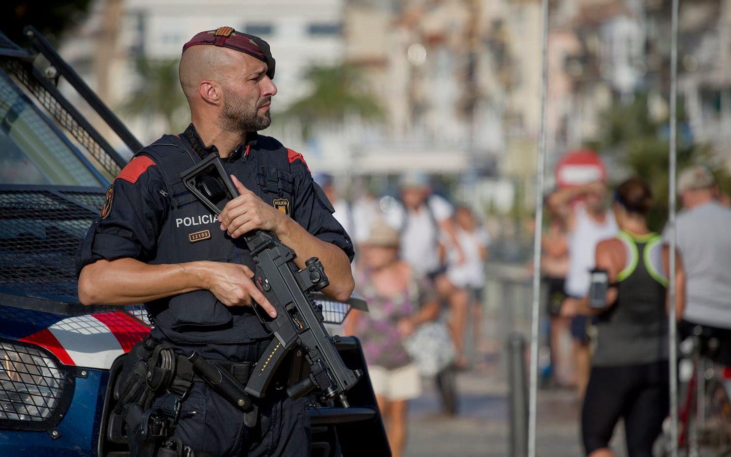 En polis står på vakt vid strandpromenaden i Cambril, på den plats där fem terrorister sköts till döds under natten till fredagen. FOTO: Emilio Morenatti/AP
