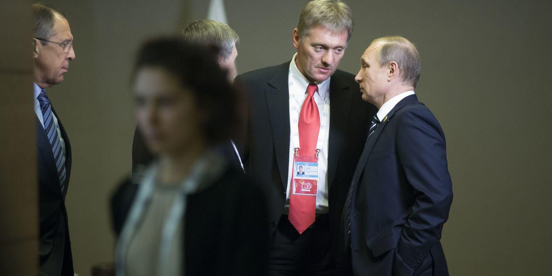 President Vladimir Putin i samspråk med Kremls talesman Dimitrij Peskov.