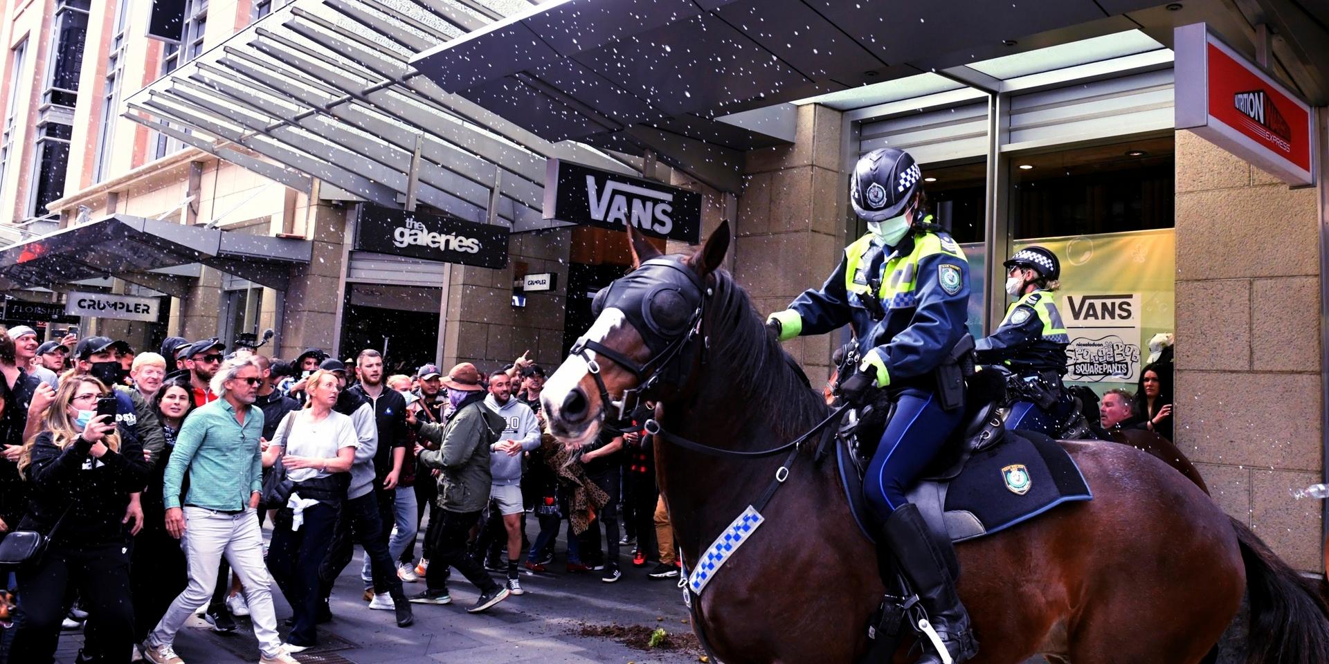 Polis i Sydney försöker hindra demonstranternas framfart.