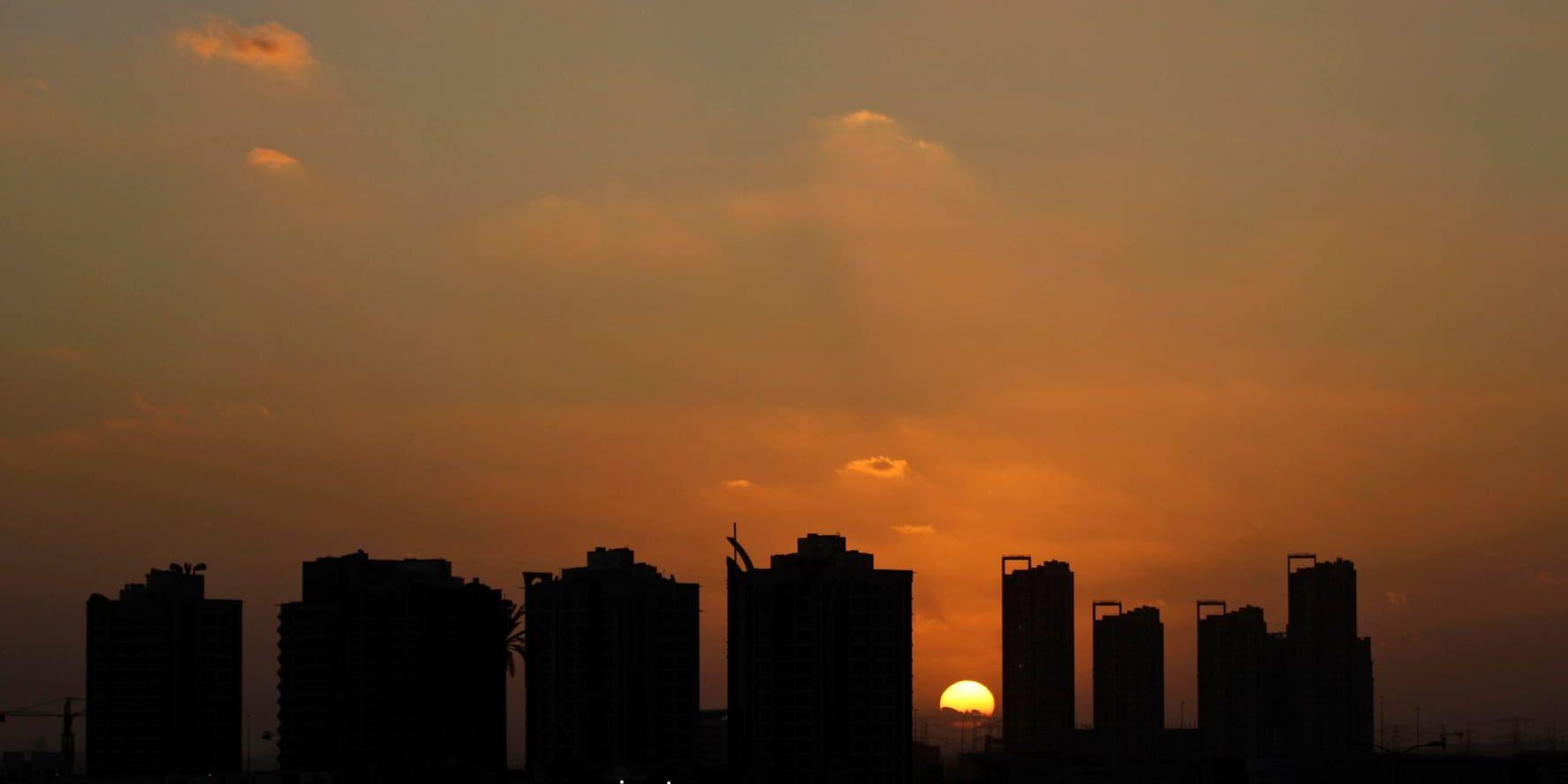Solnedgång bakom Dubai Sports City. Arkivbild.