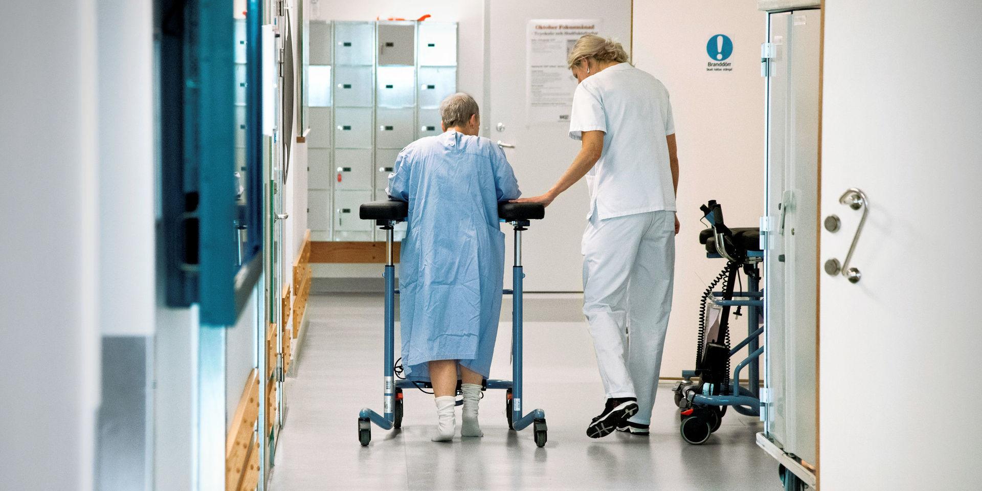 STOCKHOLM 20171107
En kvinnlig patient med en rollator får hjälp av personal att ta sig fram i en korridor på ett sjukhus 
Foto: Claudio Bresciani / TT / Kod 10090 