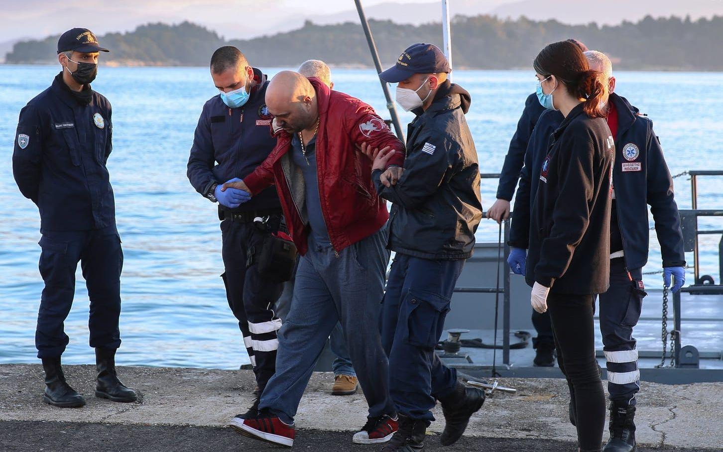 En man från det brinnande kryssningsfartyget hjälps i land av grekisk kustbevakning på Korfu.