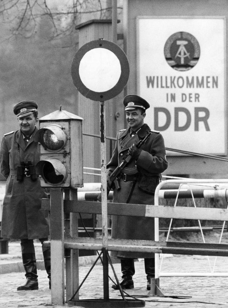 Två östtyska gränsvakter som vaktar gränsen mellan Öst- och Västberlin.