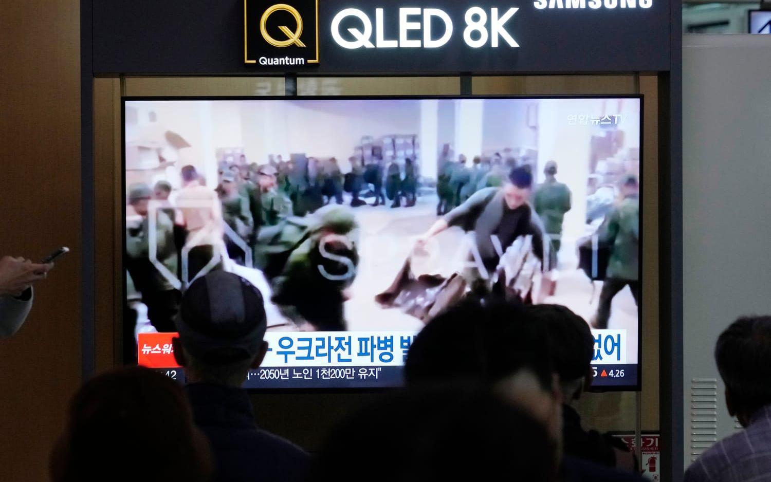 Soldater som tros vara från Nordkorea köar för att få materiel från Ryssland visas på ett nyhetsprogram i Sydkorea. Bilden är från i måndags.